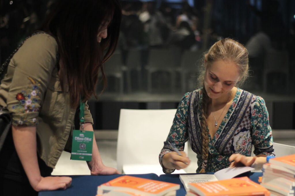 Ashley signing her minibook Unlocking the World’s Largest E-Market on the benefits of customer centricity.