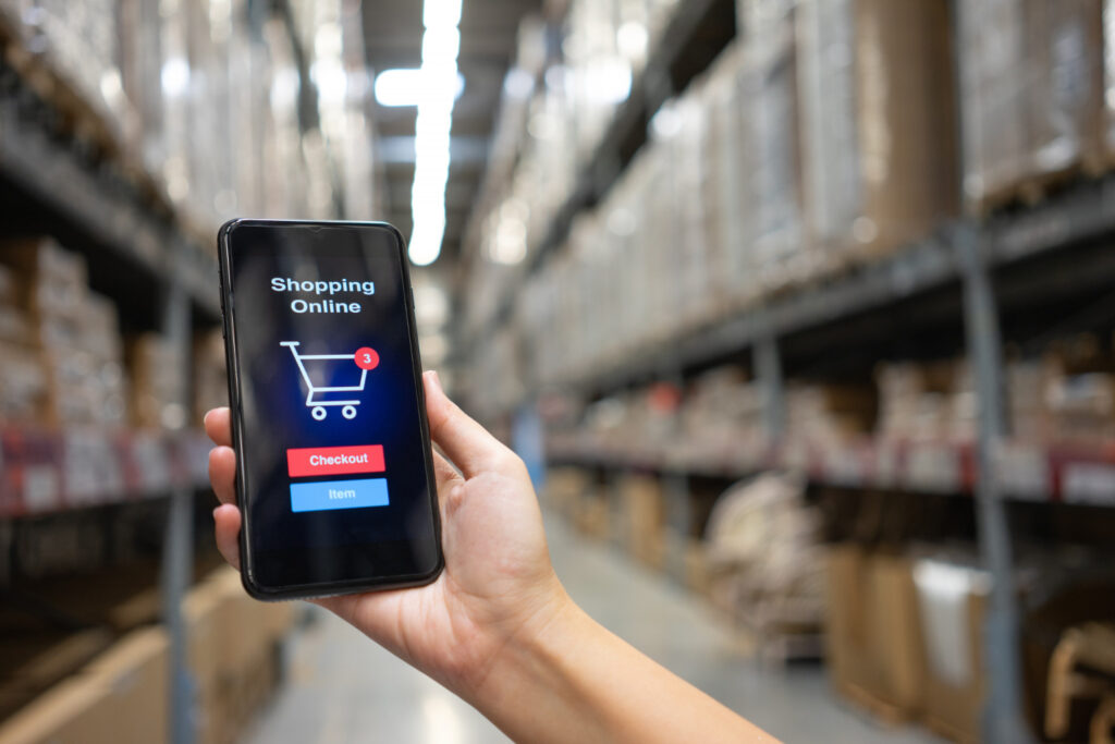 Mobile shopping interface with warehouse logistics in background