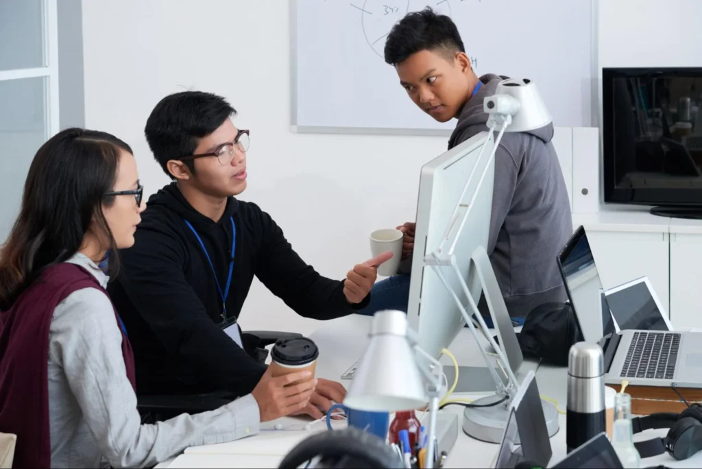 Young tech team discussing AI projects in a modern office