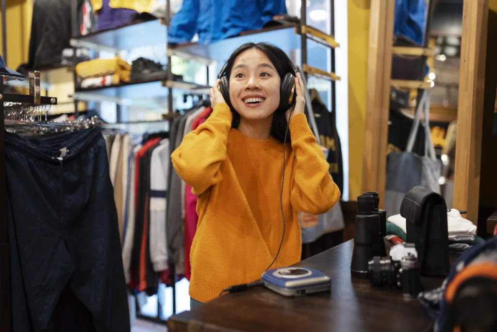 Virtual shopping: Young woman enjoying an in-store experience while testing headphones in a retail shop
