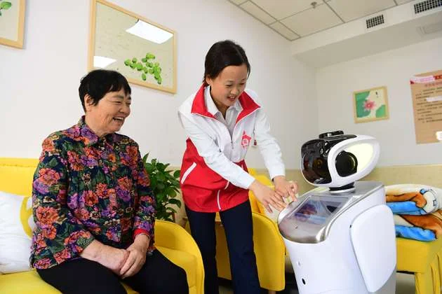 Elderly woman interacting with a service robot during a guided demonstration in a community center in China