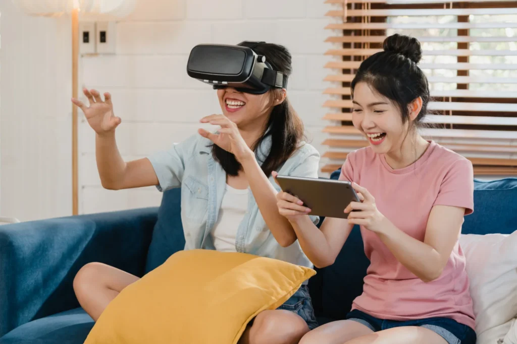 Young women using virtual reality headset and tablet at home, reflecting everyday digital experiences shaped by Chinese AI in 2026.