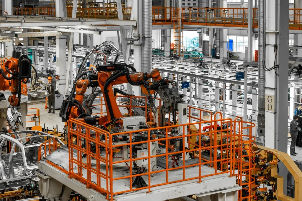 Robotic arms operating inside a modern manufacturing plant, demonstrating industrial automation driven by Chinese AI in 2026.