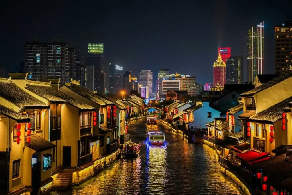 Night canal town in China representing travel and experience-led spending for decompression.