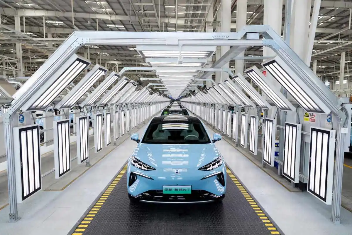 Electric vehicle moving through an automated production line in China