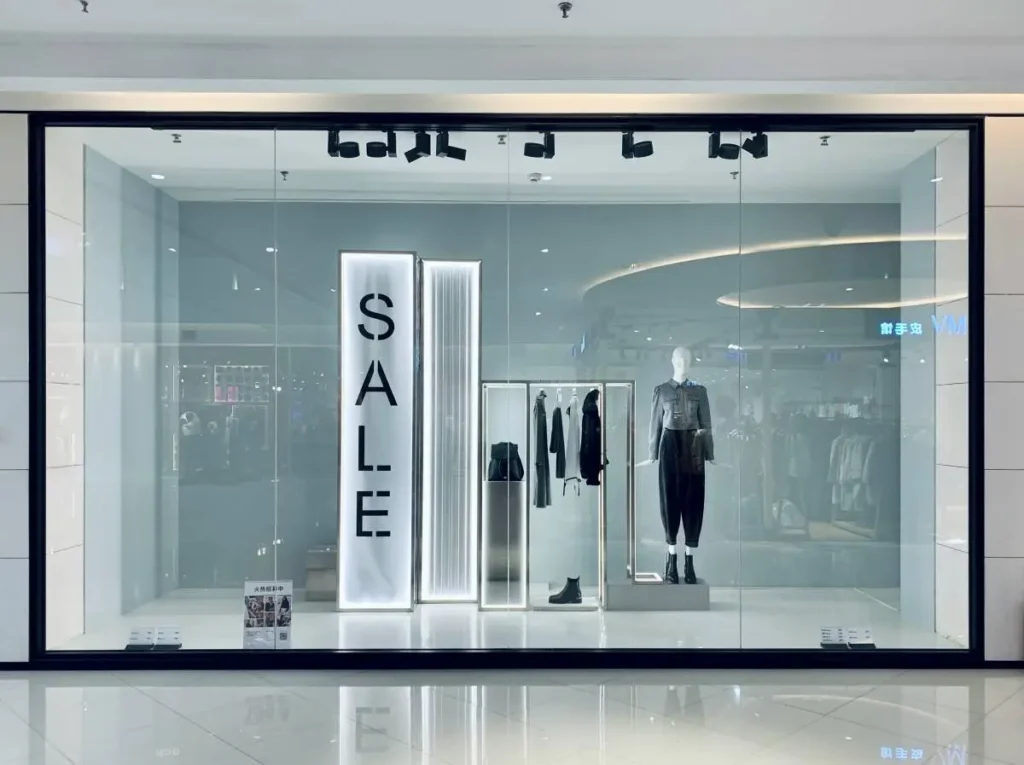 Minimal fashion storefront with clothing display inside a shopping mall