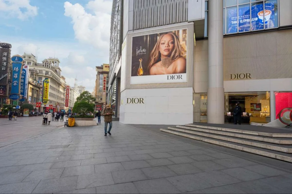 Luxury fashion storefront in a China shopping district with premium branding on display