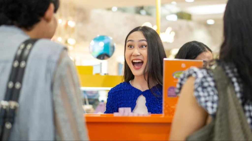Shopper reacting at a retail counter in China, reflecting selective emotional spending.