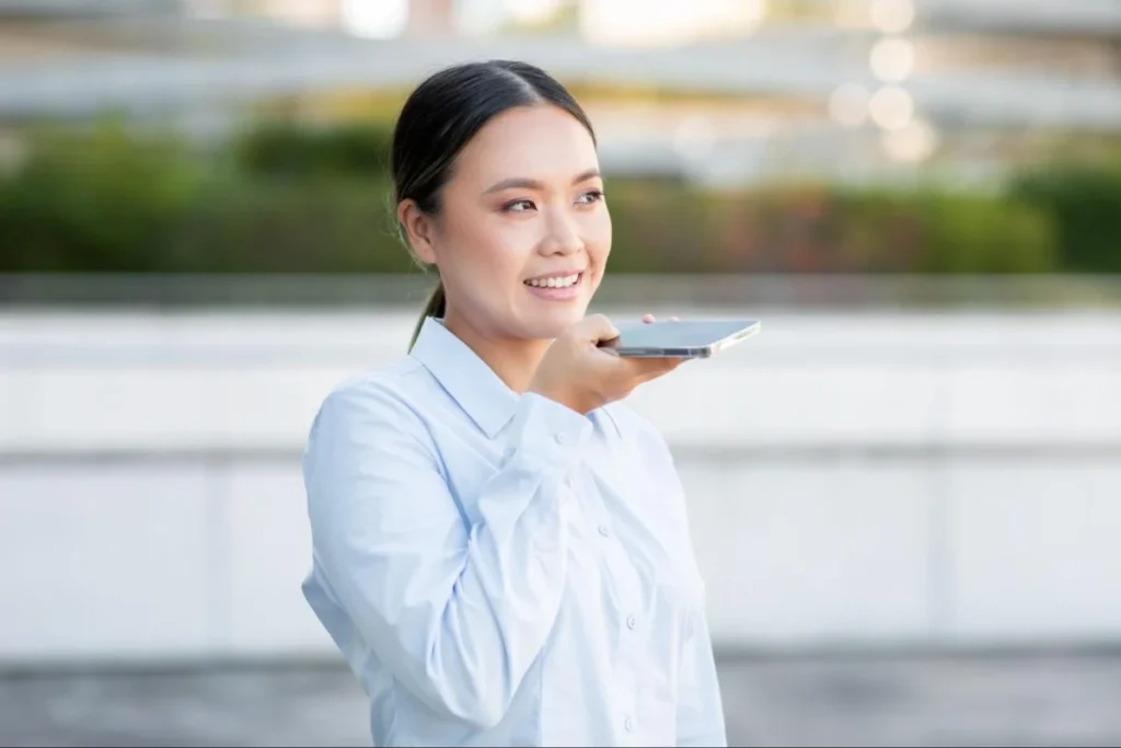 Woman speaking to a smartphone assistant, illustrating voice-enabled and personalized shopping experiences in China.