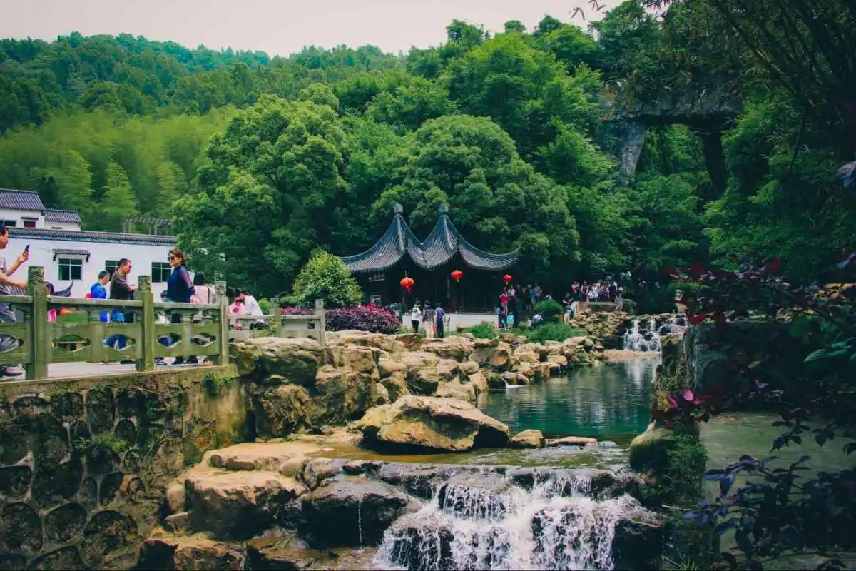 Visitors walk through a traditional Chinese garden, reflecting demand for calm and meaningful experiences in China.