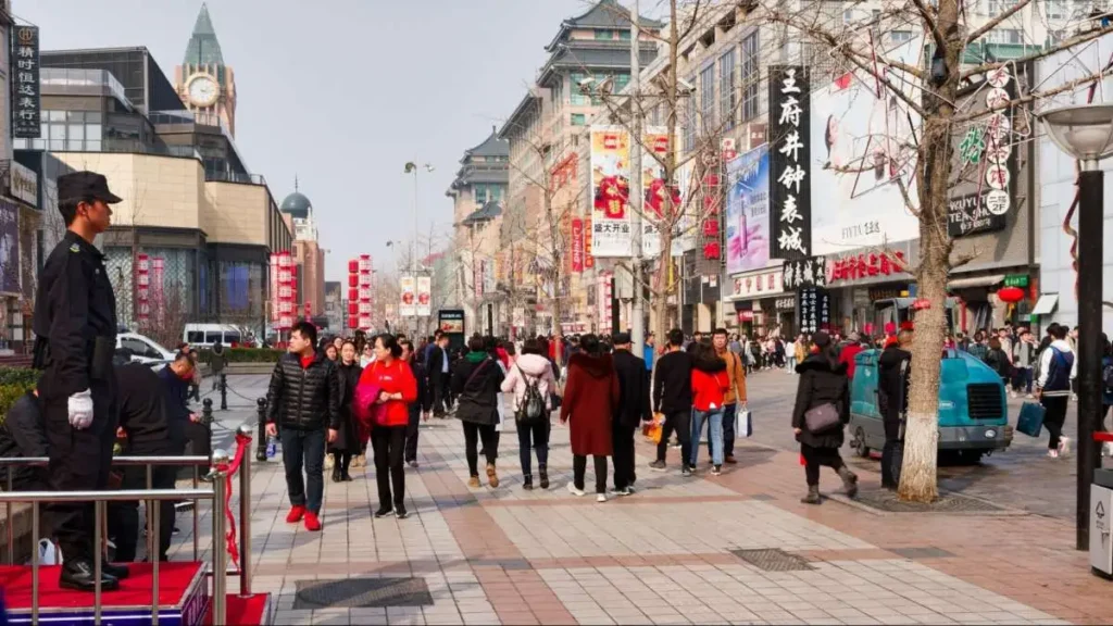 Shoppers on a Chinese retail street, representing the need for consistent proof and trust-building brand strategy.