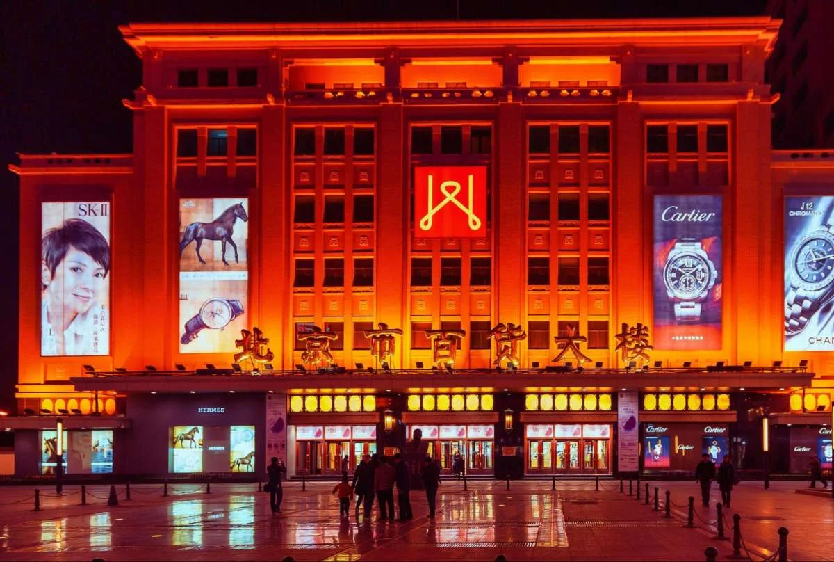 Illuminated Chinese retail building showing how sudden public attention can test brand trust.