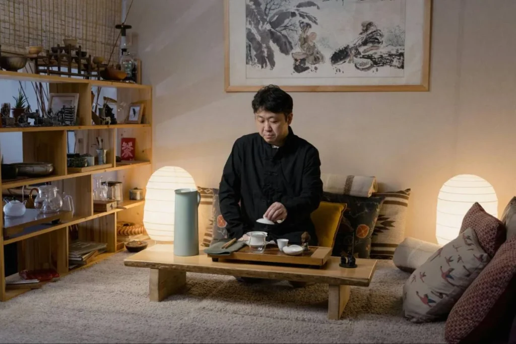 Man relaxing in a compact home, showing how solo living shapes appliance, furniture, and space-efficient product design.