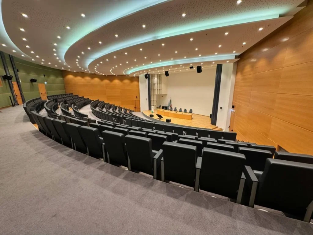 Empty auditorium prepared for a conference keynote speaker session with executive audience seating