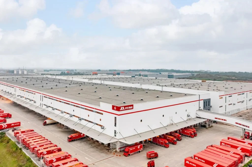 JD.com logistics warehouse with delivery trucks highlighting large-scale supply chain and fulfillment infrastructure