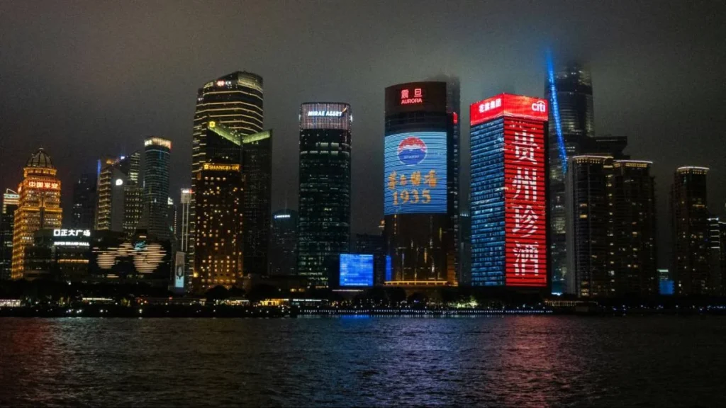 Night skyline in China showing major brand displays, reflecting how trusted brands stay visible in consumers’ daily lives.