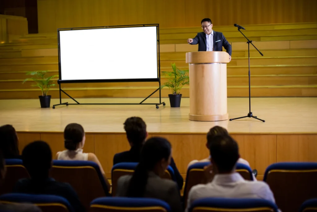 keynote speakers for hire: Speaker presenting to audience