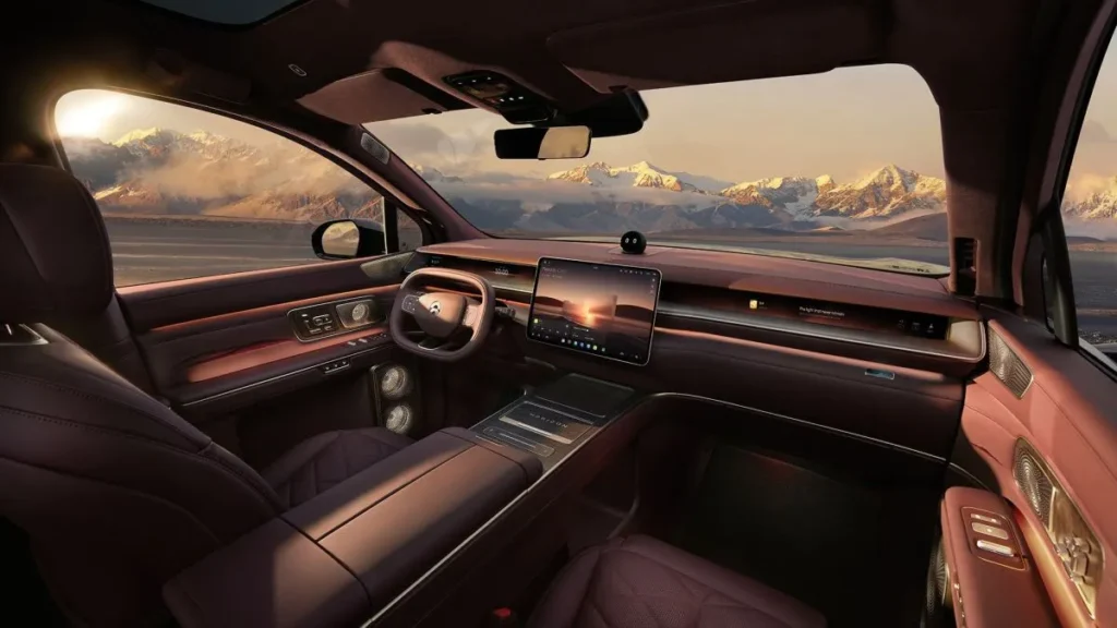 NIO electric vehicle interior with a smart dashboard and mountain view through the windshield.