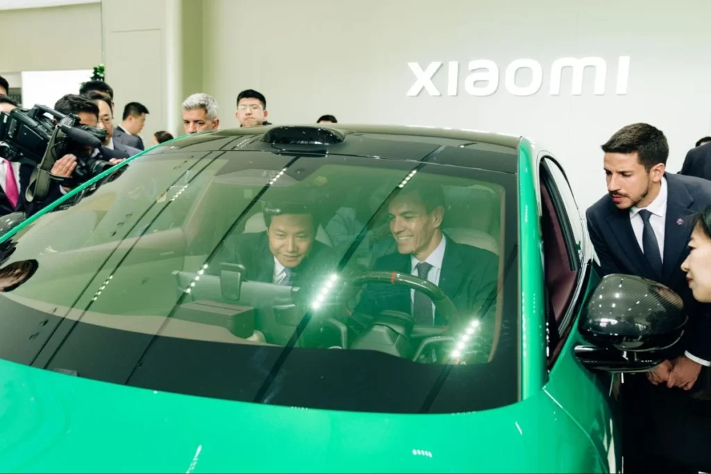 Visitors view the Xiaomi SU7, showing how phone, car, and smart home ecosystems connect.