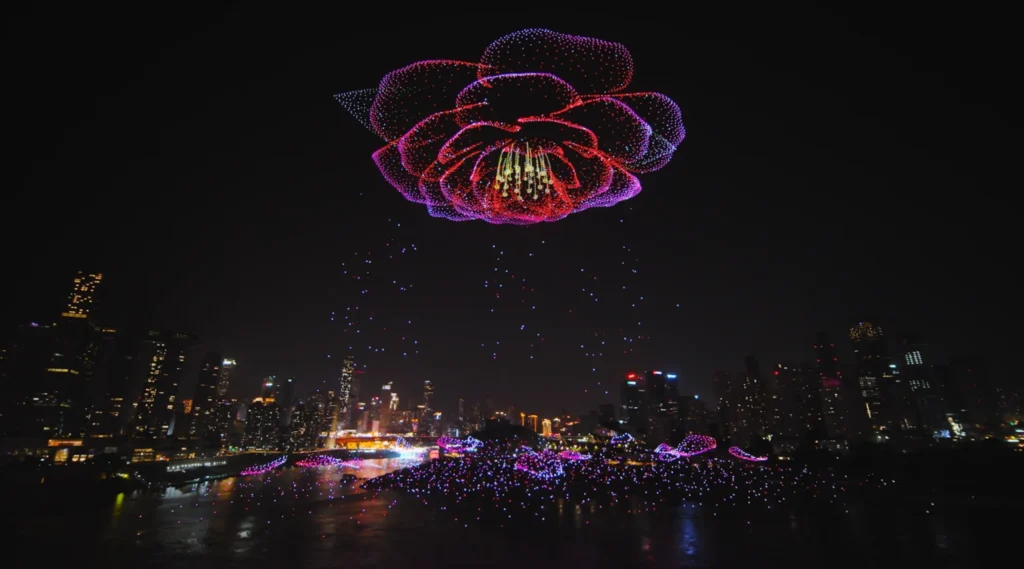 Drone advertising: light show forming a large glowing flower over the