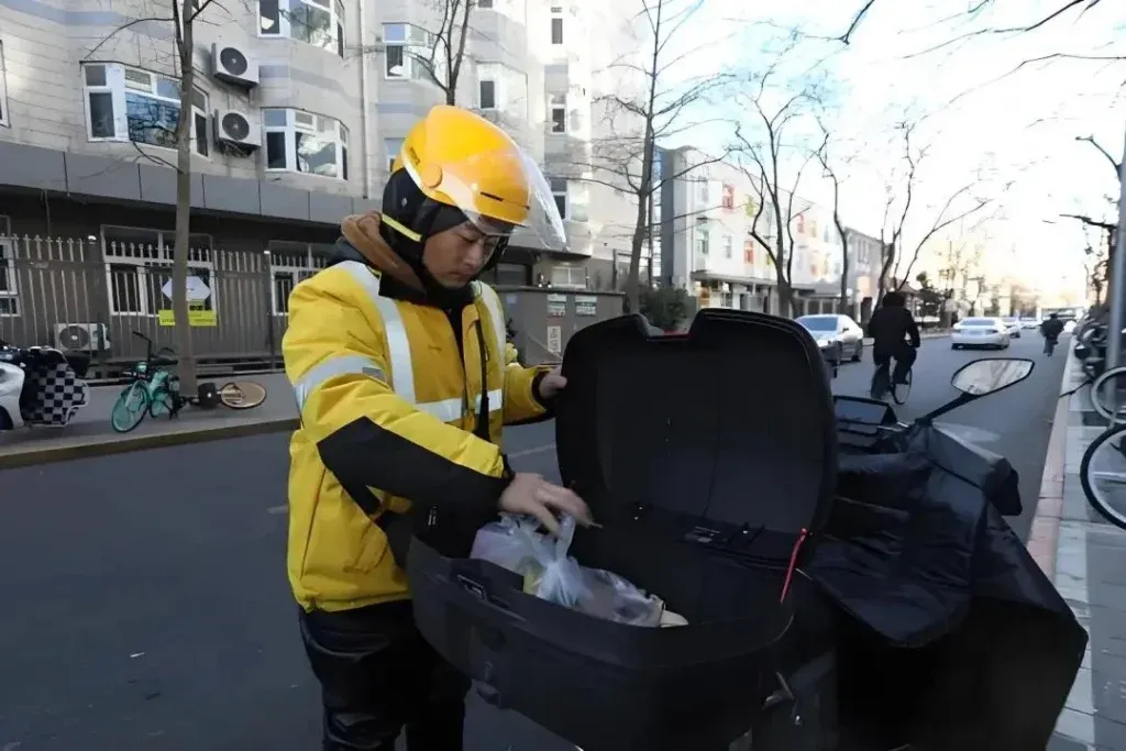 Delivery rider carrying a branded grocery bag outdoors