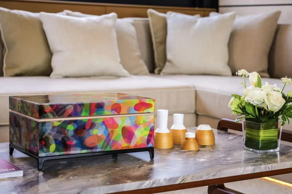 Colorful lacquer box and small woven vessels on a luxury table