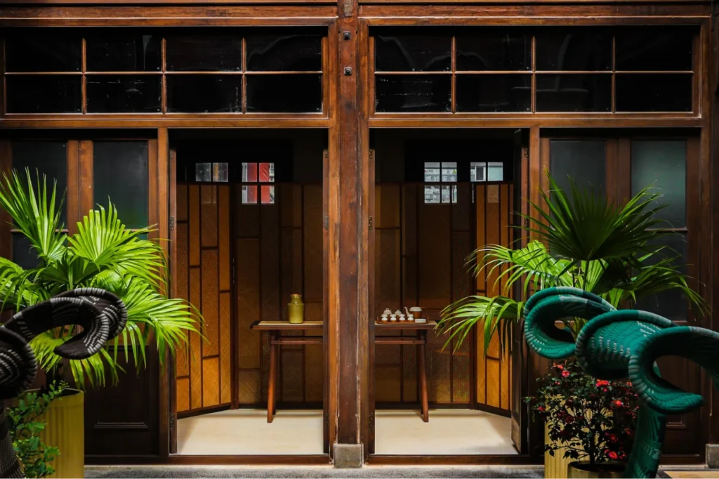 Elegant Shang Xia tea room with wooden screens and green plants
