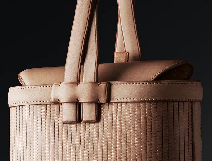 Close-up of a woven leather Shang Xia bag with stitched handles