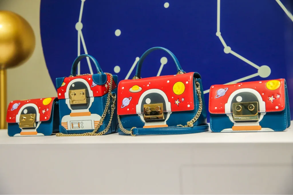 DISSONA astronaut-themed handbags on display