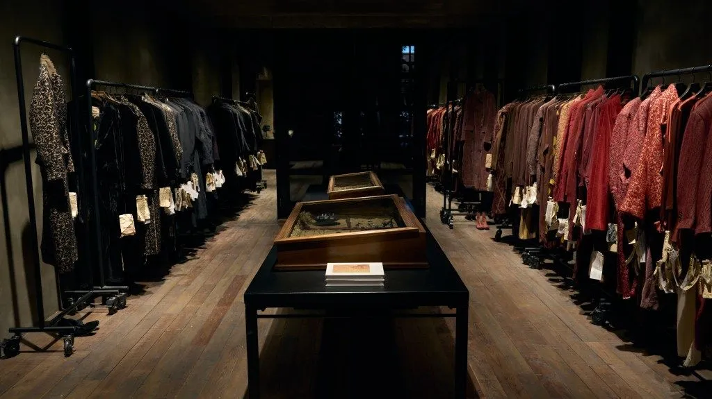 Dim boutique interior with racks of designer clothing