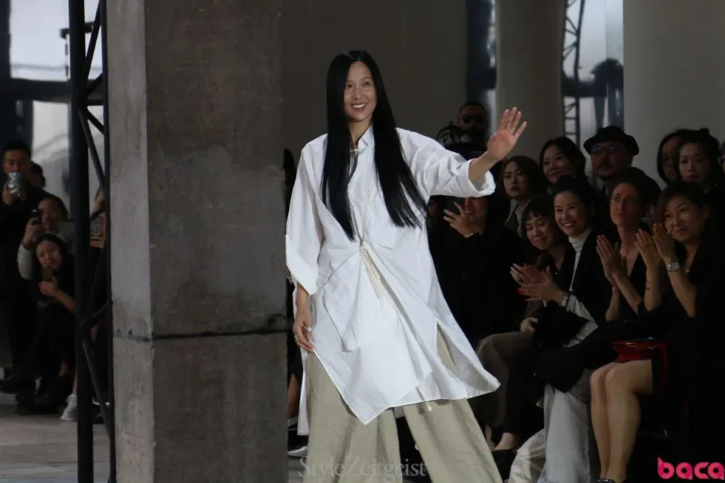 Chinese fashion designer waving after a runway show