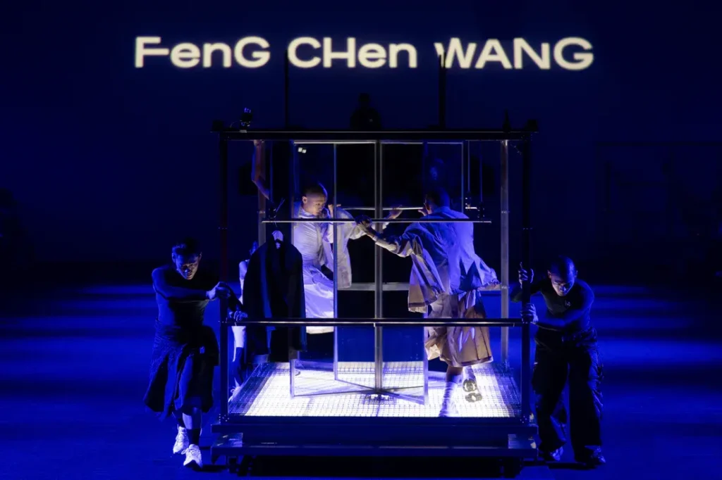 Feng Chen Wang runway show with dancers and illuminated stage
