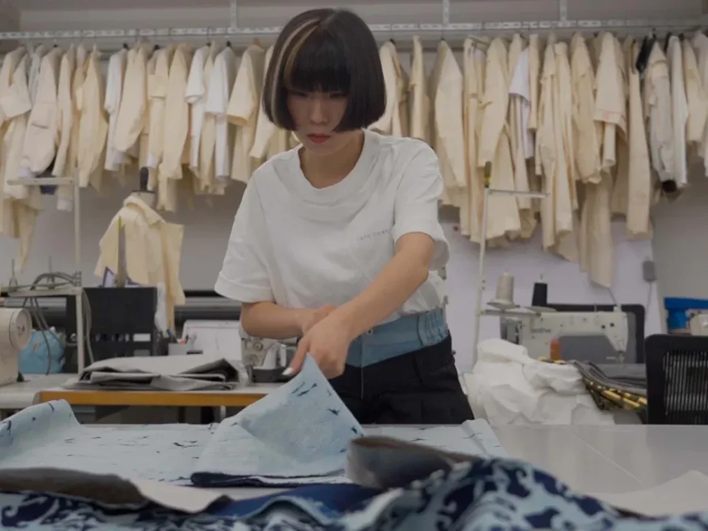 Designer working with fabric inside a fashion studio