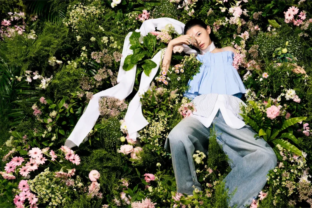 Model wearing Feng Chen Wang womenswear in floral setting