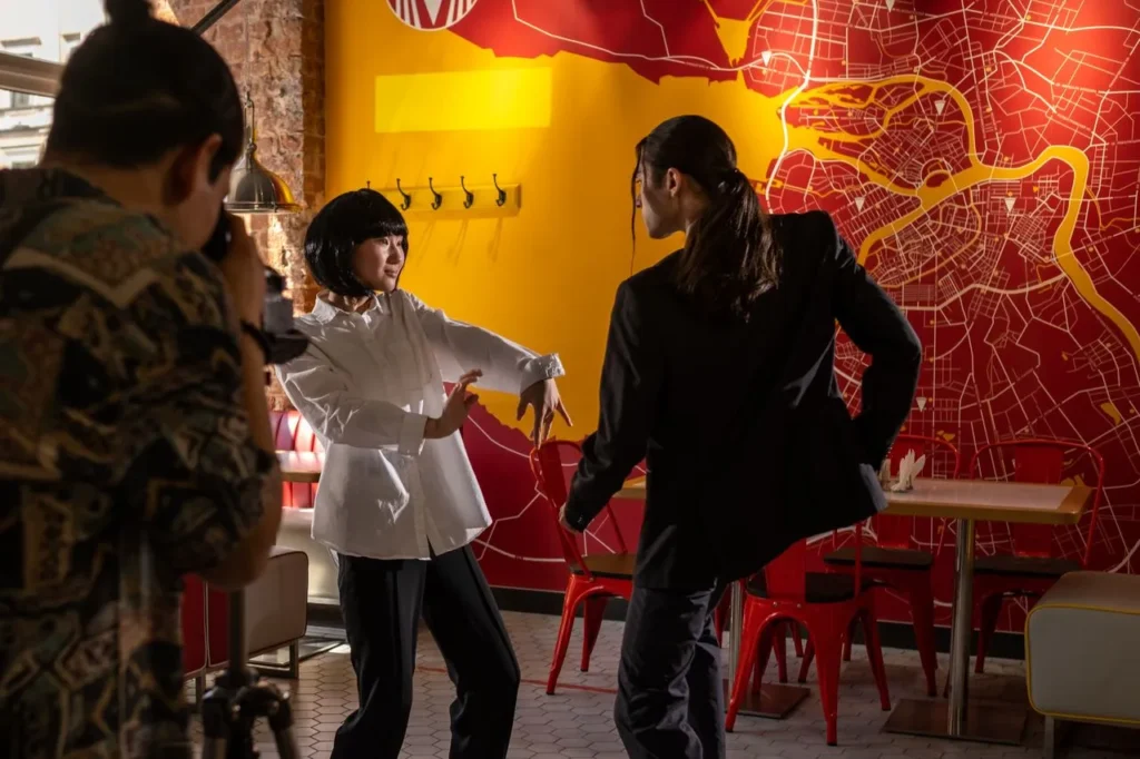 Director guiding an actor during an indoor film shoot