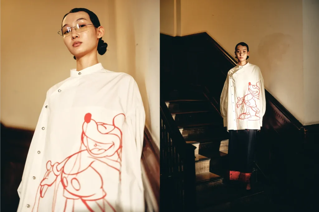 Model wearing white shirt with character artwork
