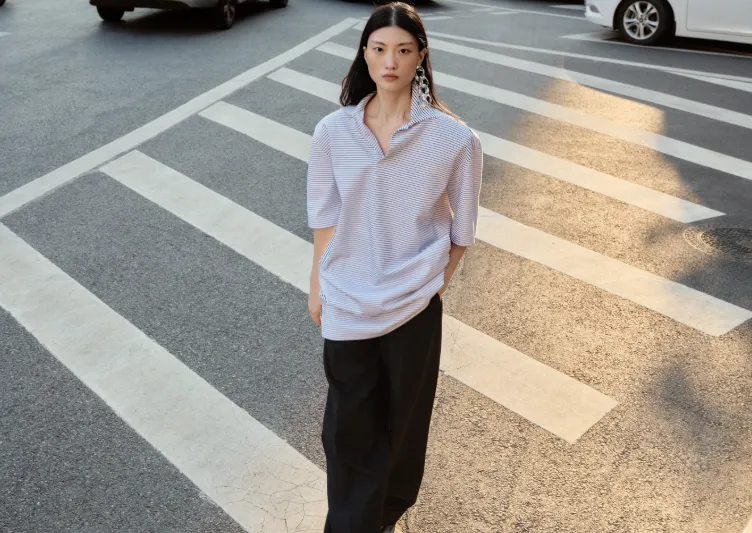 Model wearing relaxed JNBY streetwear at a crossing