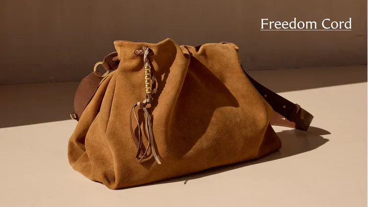 Brown suede drawstring bag with decorative cord