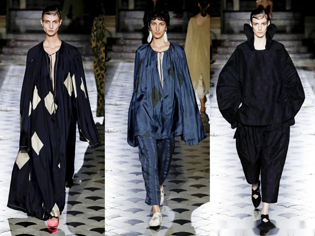 Three Uma Wang runway looks in dark layered silhouettes