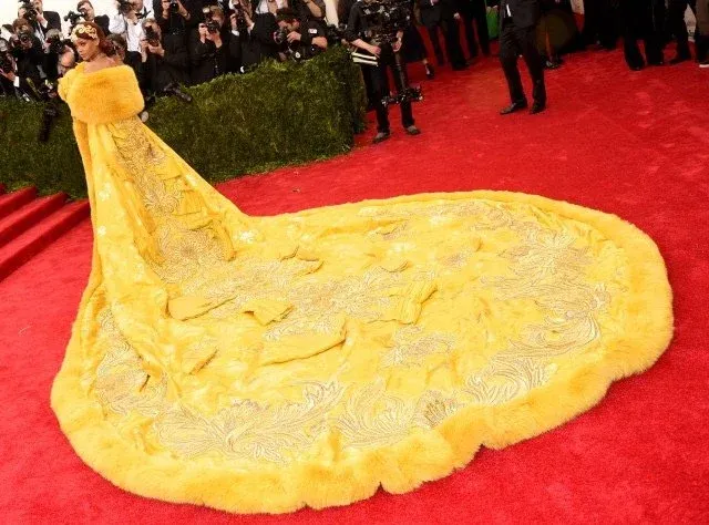 Yellow couture gown with long train on red carpet