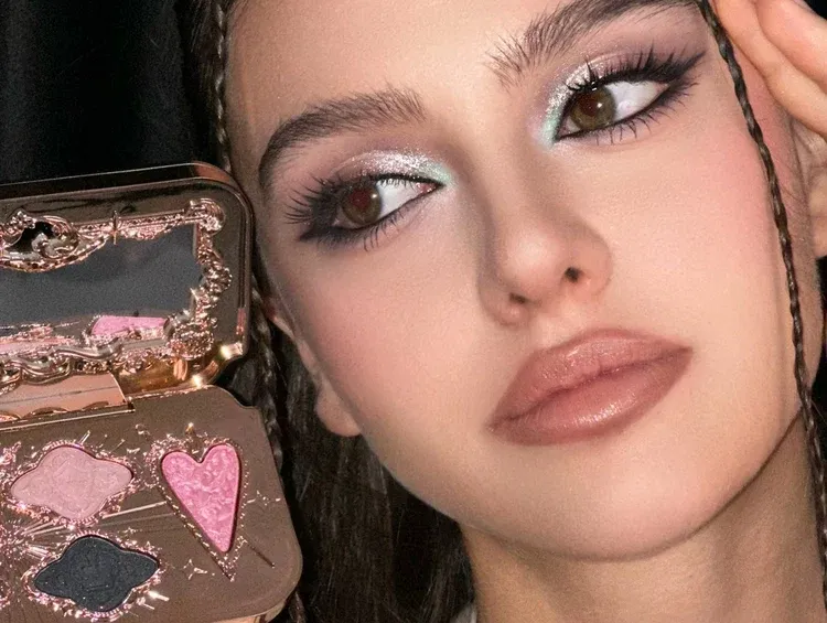 Model wearing glitter eye makeup with Flower Knows palette