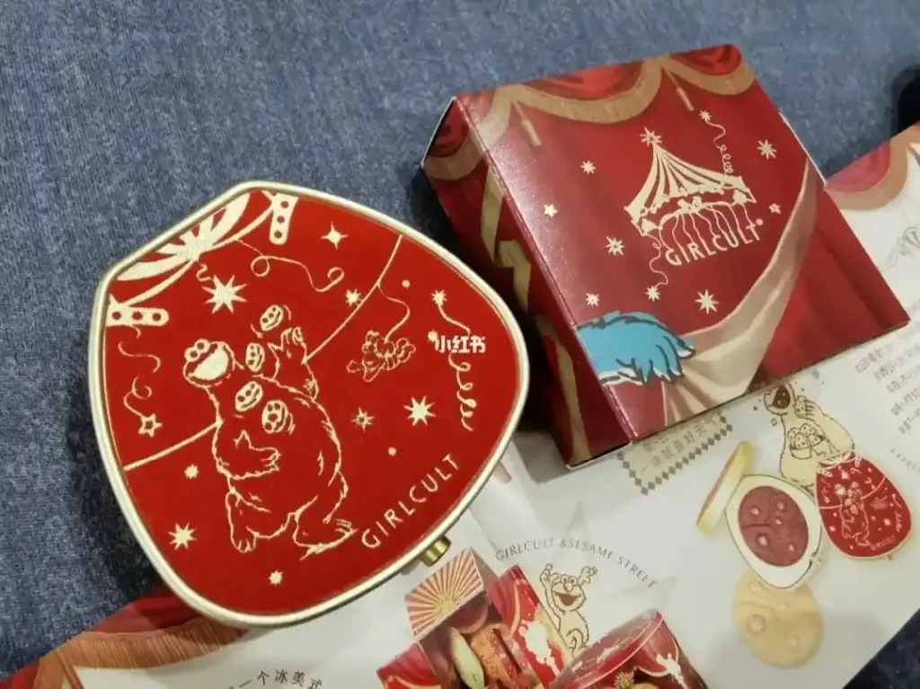 Red Girlcult compact with circus-themed packaging