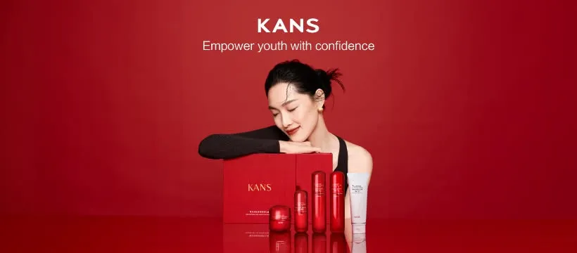 KANS red skincare campaign with a model and anti aging products on a red backdrop