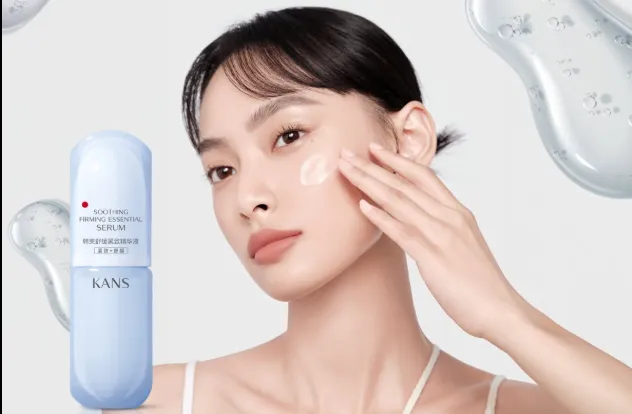 Model applying KANS soothing serum beside a blue skincare bottle on a clean background