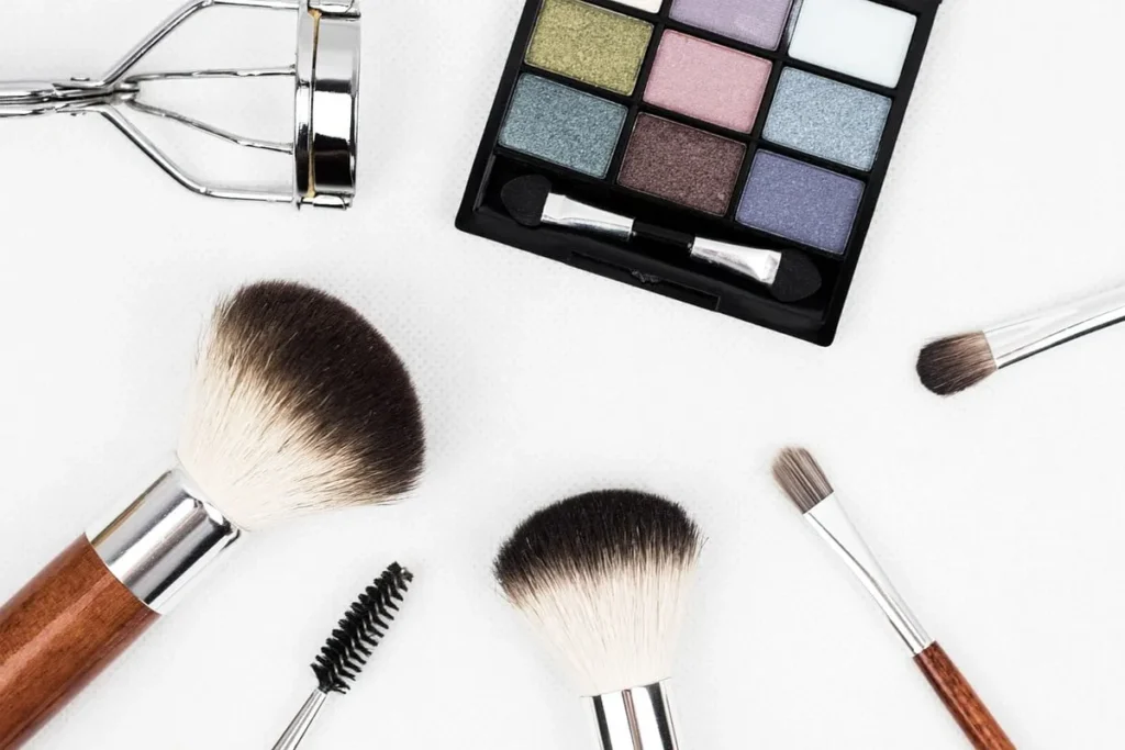 Makeup brushes with a small shimmer eyeshadow palette