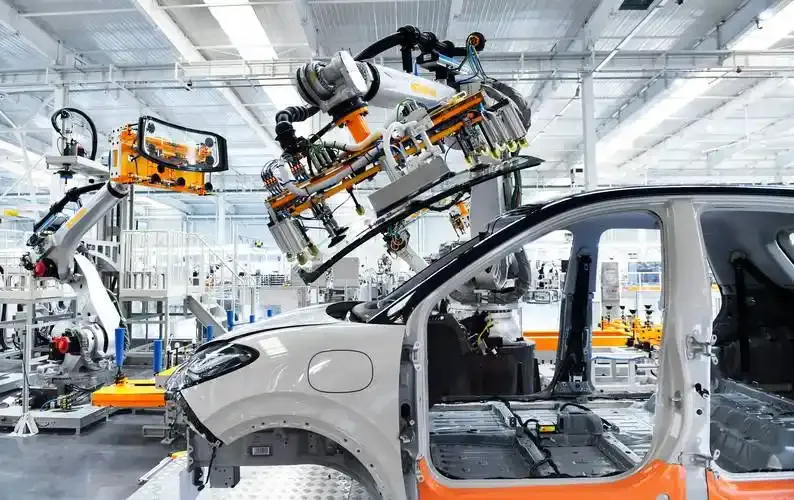 Robotic arms assembling a car in a factory