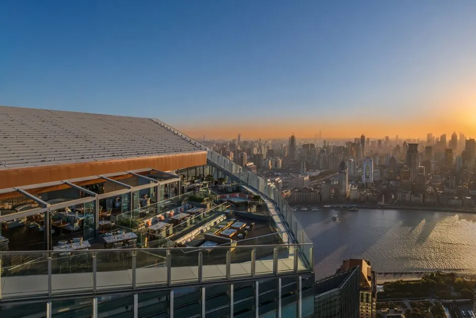 Rooftop terrace overlooking Shanghai skyline at sunset