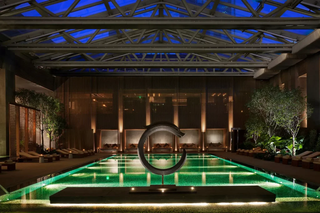 Indoor luxury swimming pool with modern sculpture